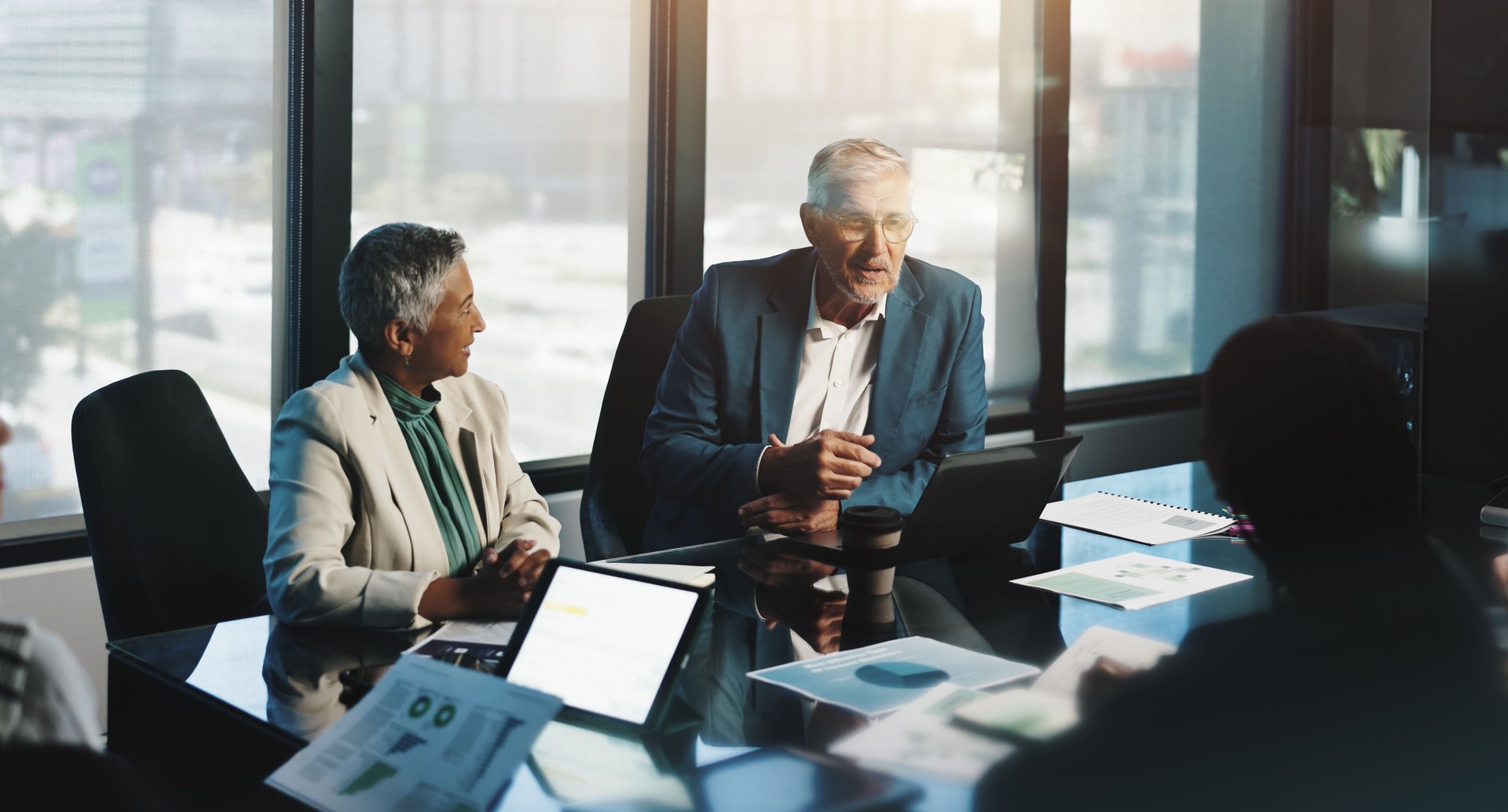 Meeting, planning and people with laptop, boardroom and discussion for stats, team and company. Corporate, colleagues and analysis of charts in business, collaboration and communication for updates